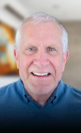 elder patient smiling with his snap-on-dentures