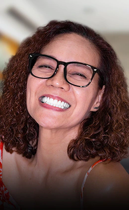 female ginger patient smiling with her all on 4 dental prosthesis