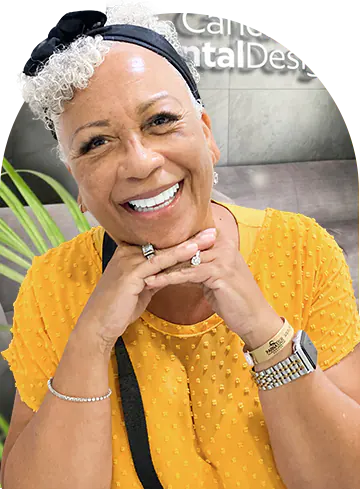 Smiling black woman who went through orthognathic surgery in Mexico at Cancun Dental Design