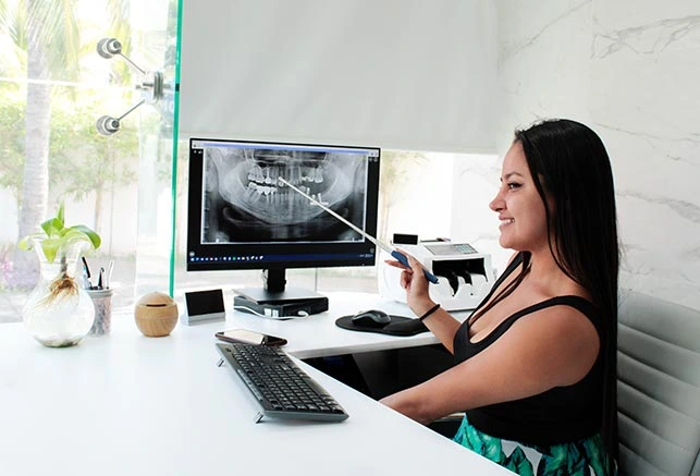 seated girl showing dental x-rays