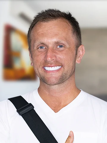 picture of young man patient at cancun dental design smiling with her dental crowns