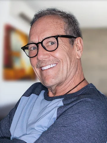 white man patient at cancun dental design smiling with his 3 on 6 dental implants