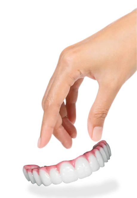 A person's hand holding a high-quality full-arch dental bridge, demonstrating the lightweight design and natural-looking gum and tooth aesthetics