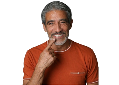 middle aged man with restored teeth happily smiling pointing at his teeth 