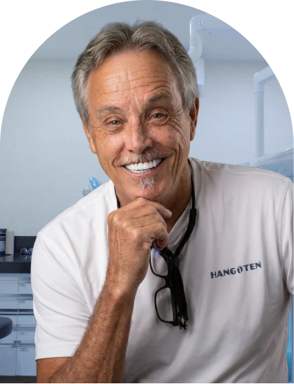 middle aged man posing with a bright and wide smile