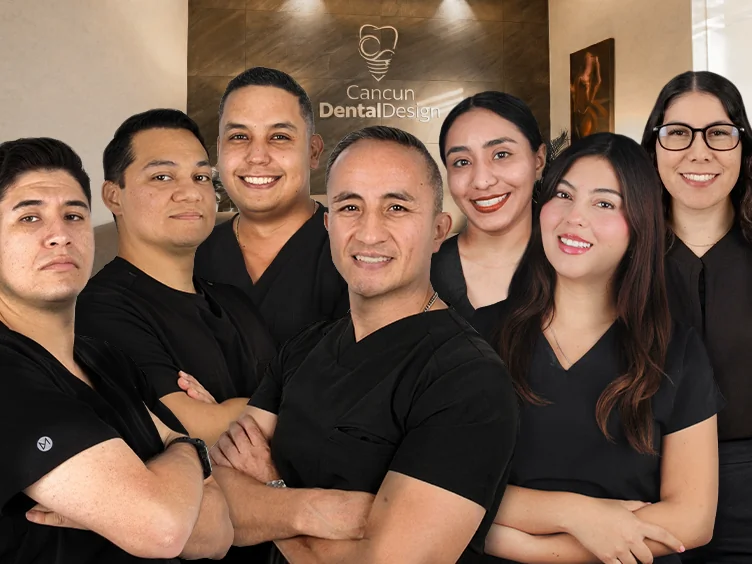 Team dental specialists at Cancun Dental Design smiling in front of the clinic's reception desk.