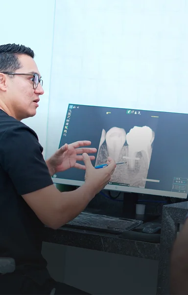 Dental specialist discussing personalized implant treatment plan in Cancun.